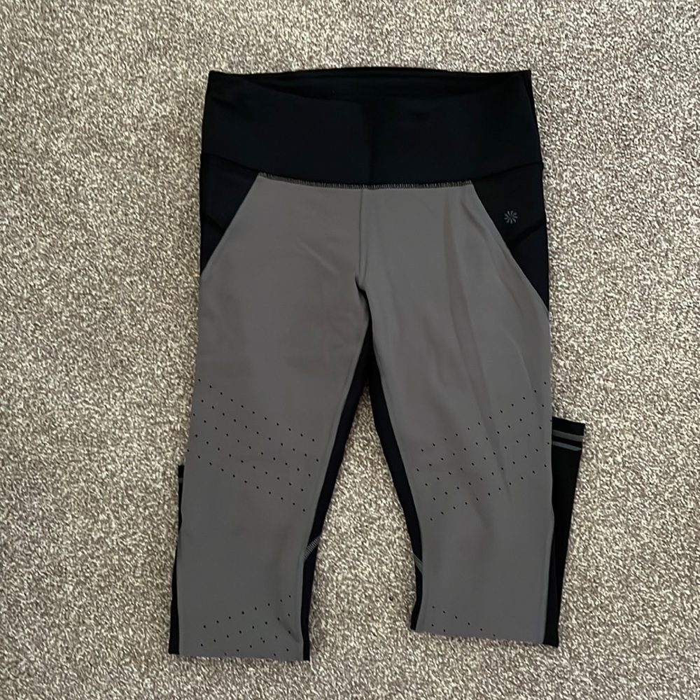 Athleta size medium workout compressive leggings in color black. Ankle length